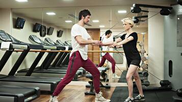 A gym with treadmills, weights, and mirrors.