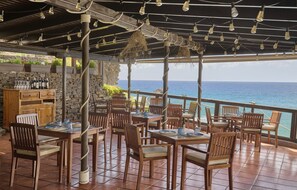 Guests can dine al fresco with a view of the ocean from this outdoor dining area.