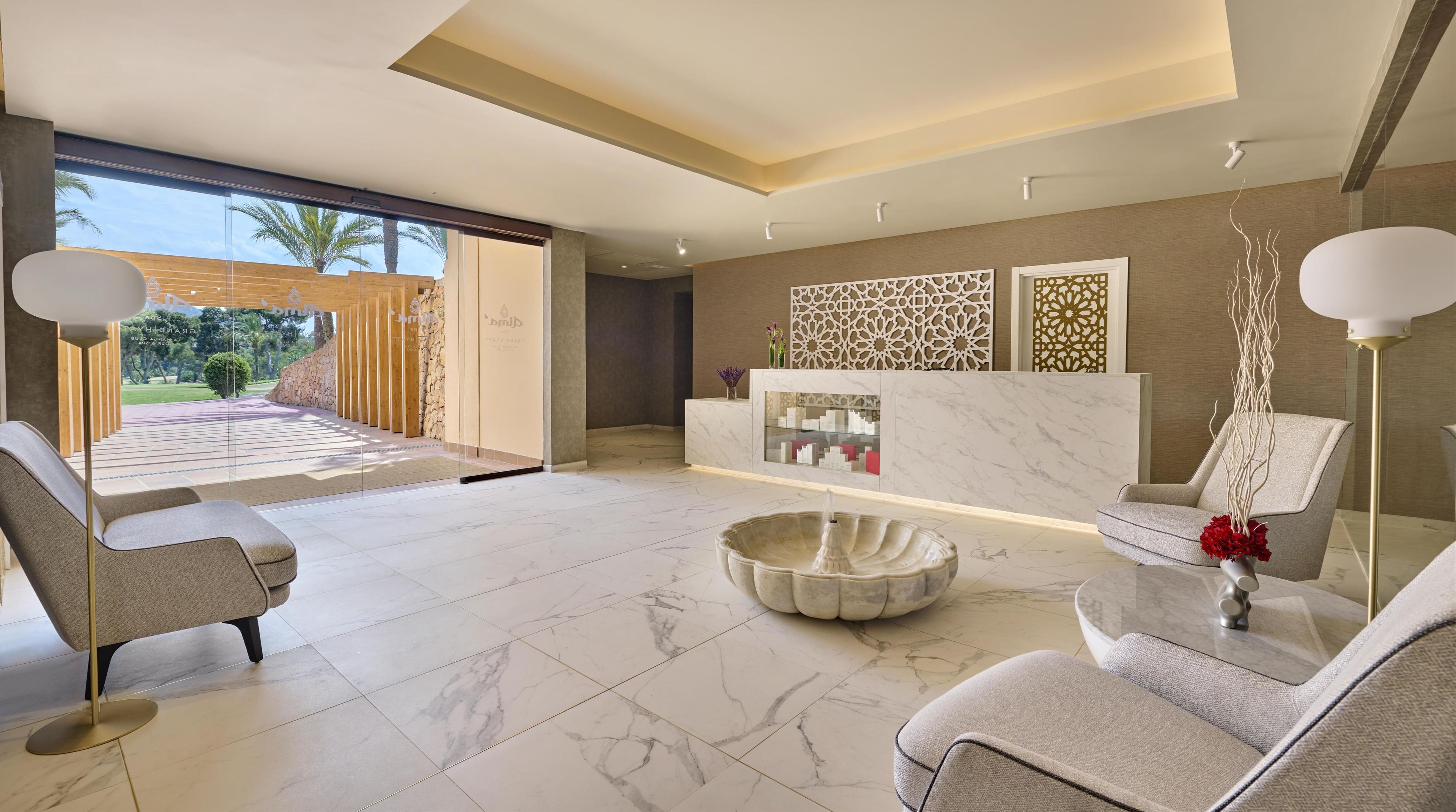 A modern living room with a marble floor, two sofas, a coffee table, and a decorative wall panel.