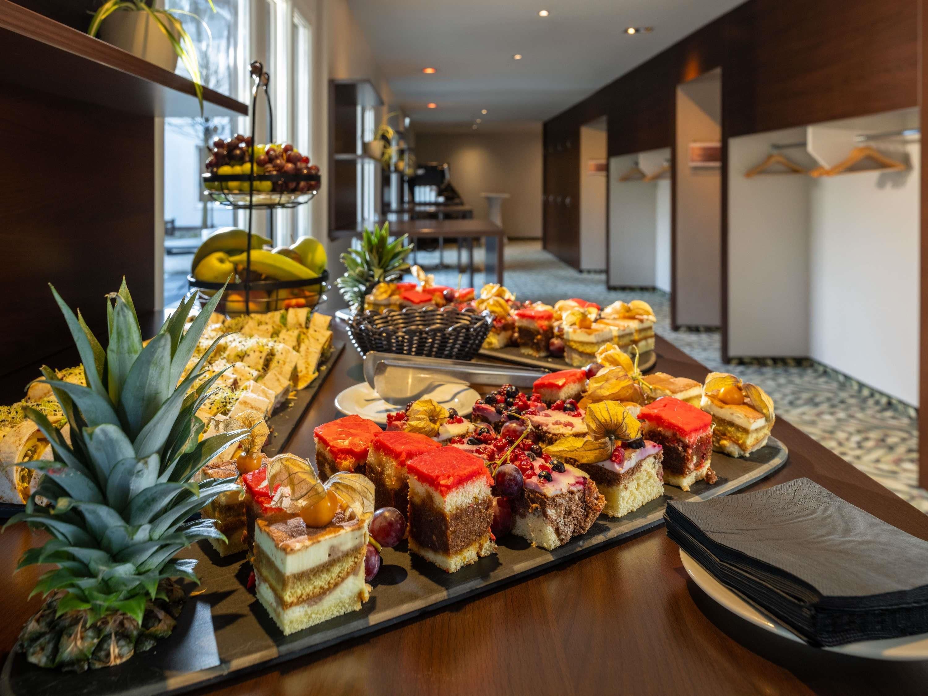 A buffet with various desserts and fruits.