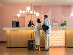 A reception desk with a modern design, a reception area, and a wooden floor. - Mercure Salzburg City (Salzburg)