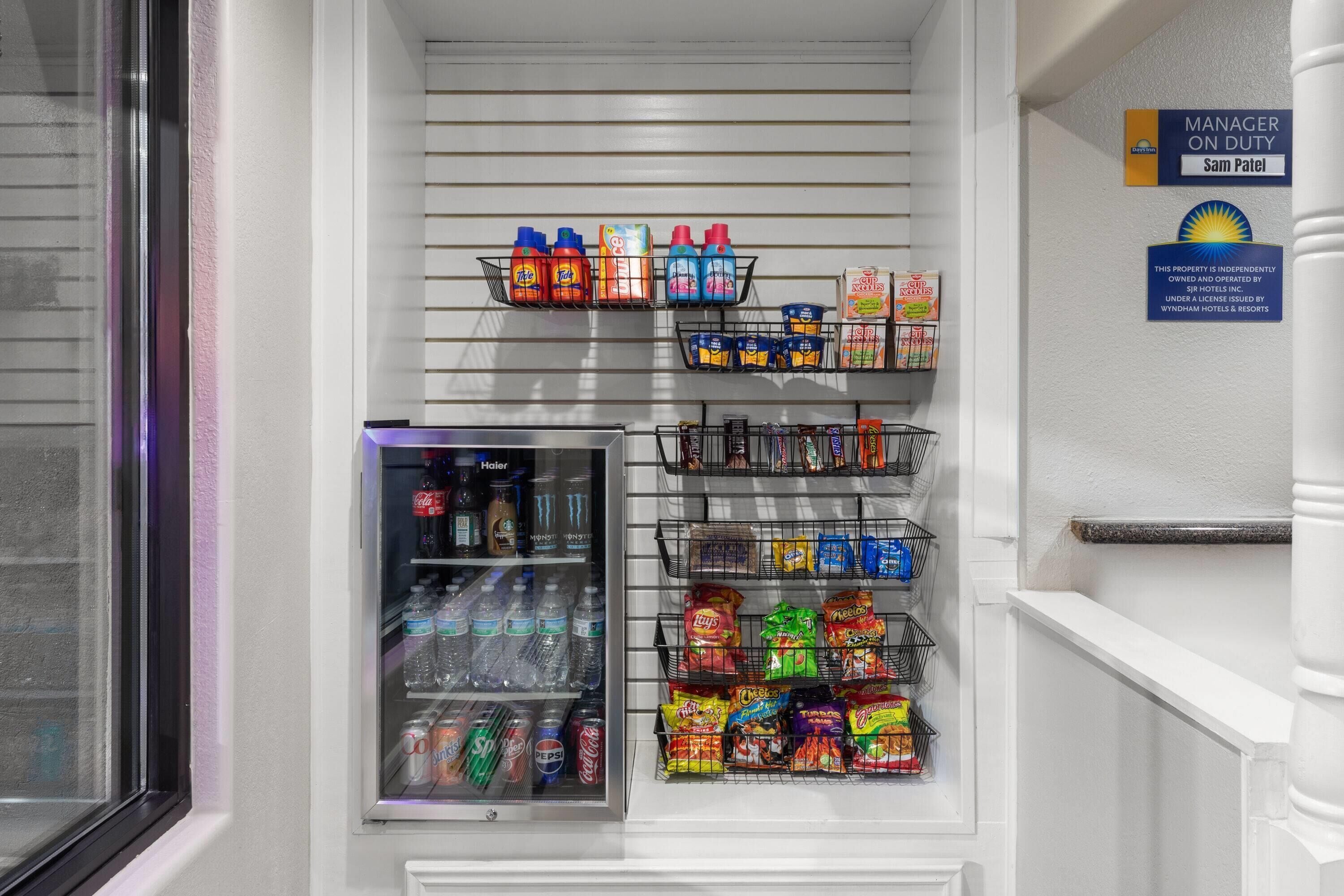 A hotel minibar with various beverages and snacks.