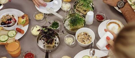 A dining table with various dishes, utensils, and a salt shaker.