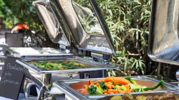A buffet with various food items including vegetables and potatoes.