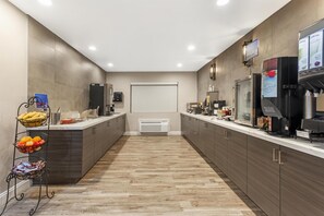 A modern kitchen with a central island, a coffee machine, and a fruit basket. - Best Western Kettleman City Inn & Suites (Kettleman City)