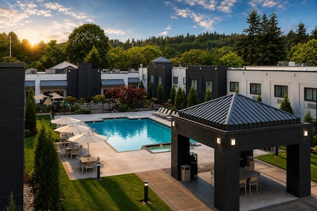 A modern hotel with a swimming pool, outdoor seating, and a gazebo.. Country Inn & Suites by Radisson, Seattle-Bothell, WA