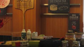 Mostrador de una panadería con letreros que dicen "PADARIA BAKERY" y "O PÃO NOSSO DE CADA DIA OUR DAILY BREAD".