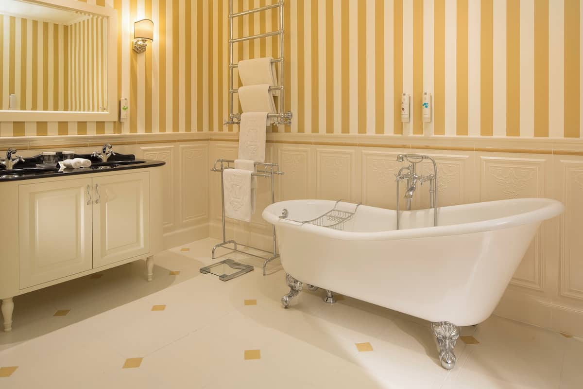 Deluxe Family Room, Courtyard View | Bathroom | Designer toiletries, hair dryer, bathrobes, slippers