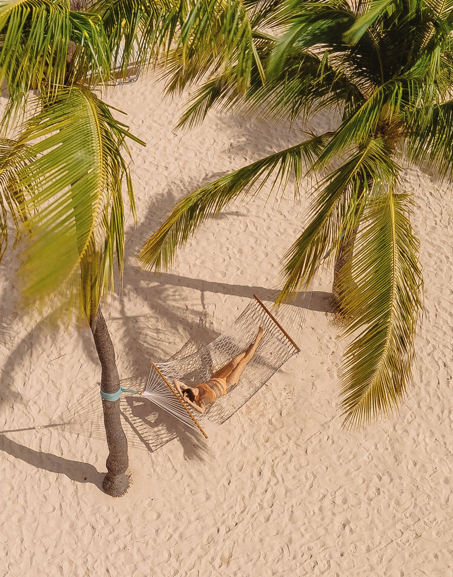 on the beach, white sand, free beach cabanas, sun-loungers