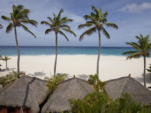 On the beach, white sand, free beach cabanas, sun-loungers