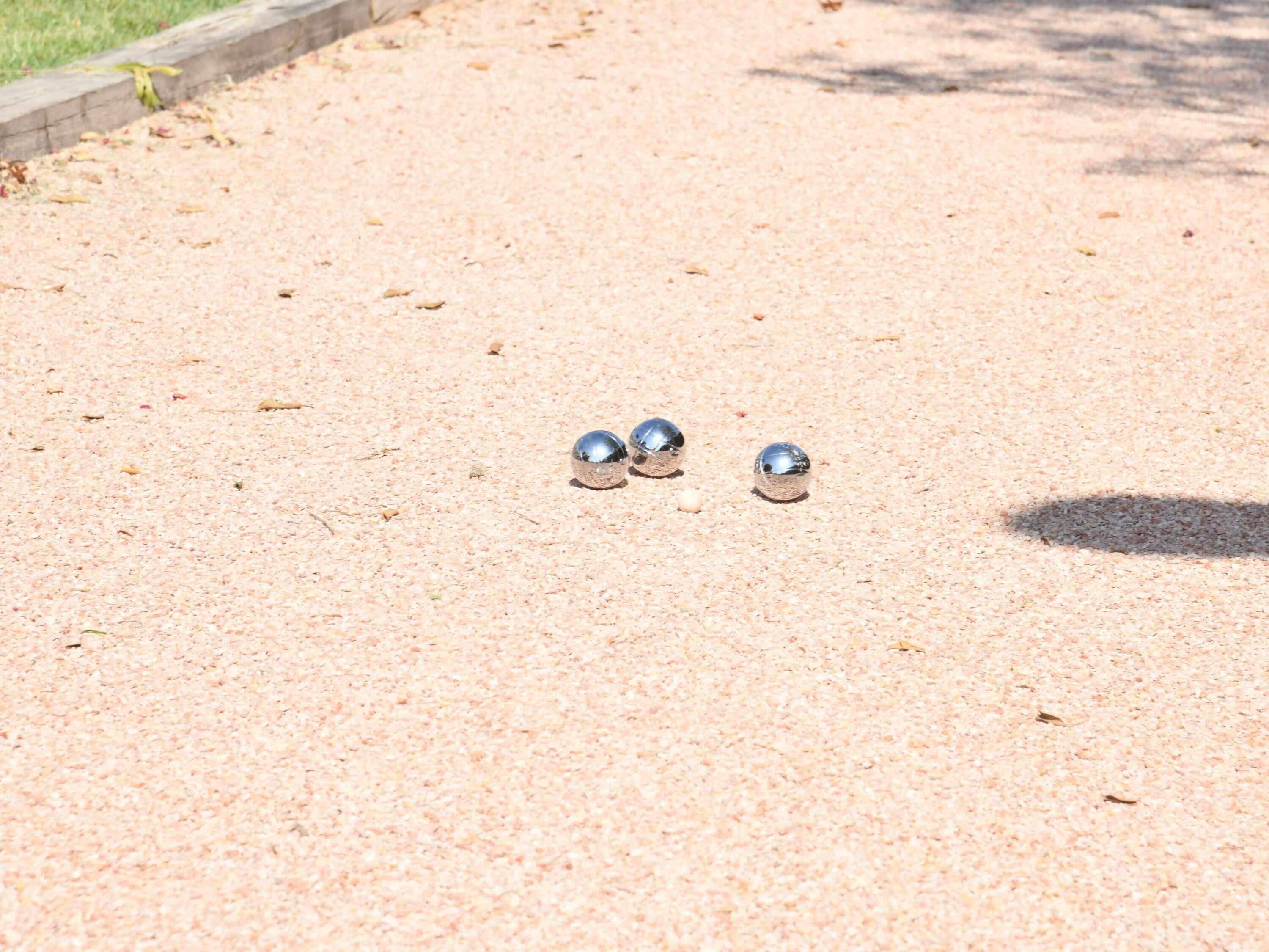 Three metallic spheres on a textured surface.
