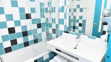 A modern bathroom with a glass shower enclosure, a white sink, and a mirror.