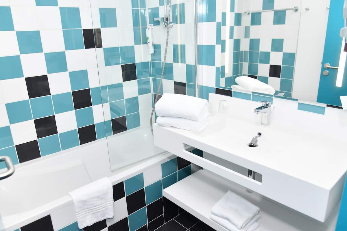 comfort family room with 1 double bed and 1 sofa | premium bedding, desk, blackout curtains, soundproofing