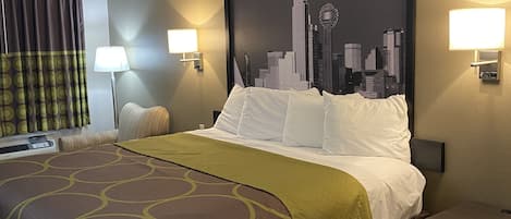 A hotel room with a large bed, two bedside lamps, a cityscape mural on the wall, and a window with curtains.