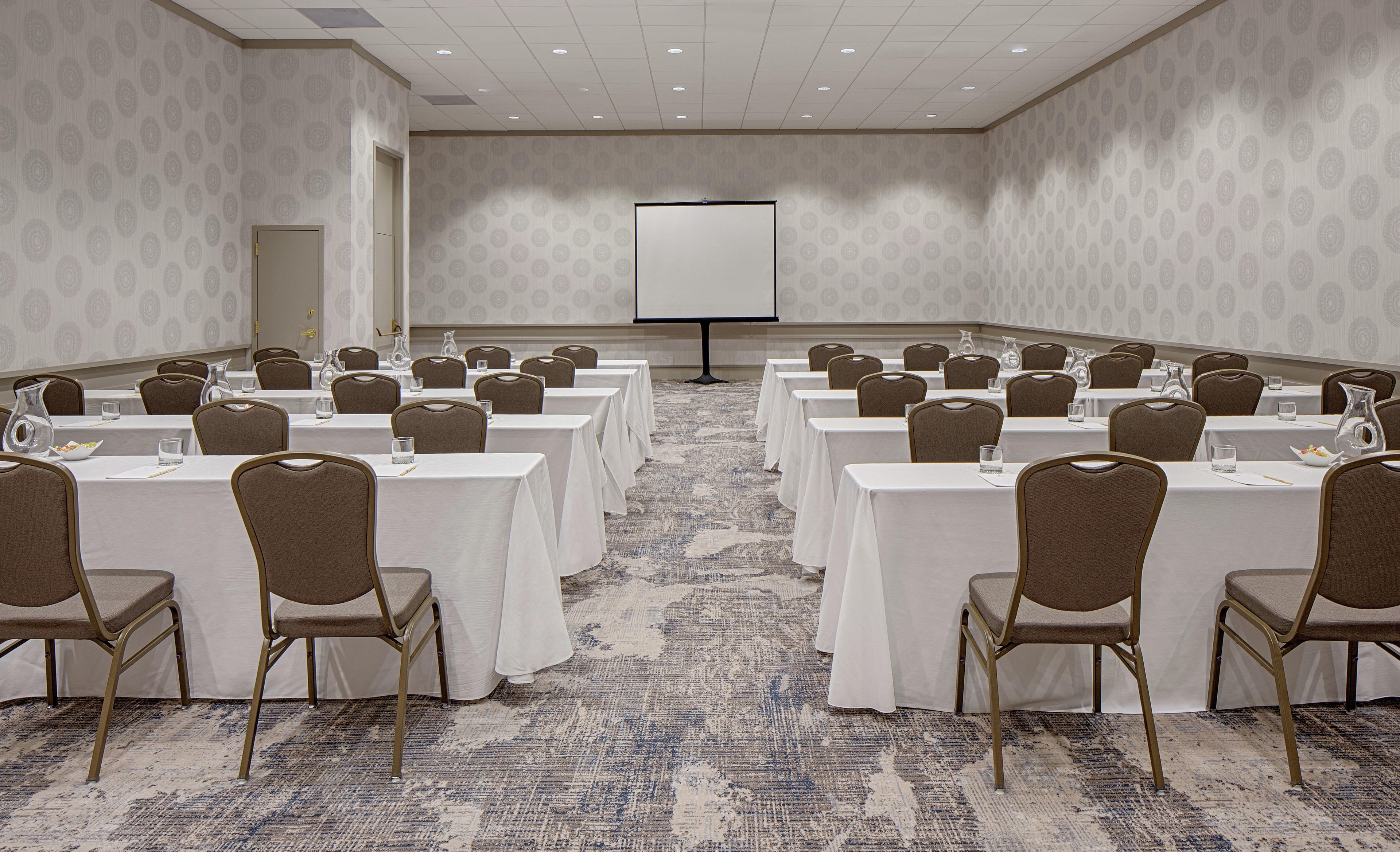 A conference room with tables and chairs arranged for a meeting.
