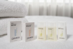 A set of five Giovanni body care products on a white surface with a white towel in the background. - Embassy Suites by Hilton Seattle Tacoma International Airport (Tukwila)