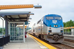 A train station platform with a blue and silver train marked with the number 44. - Embassy Suites by Hilton Seattle Tacoma International Airport (Tukwila)