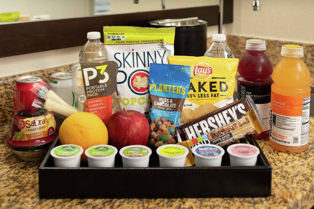 A variety of food items and snacks on a kitchen counter.