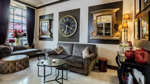 A living room with a sofa, coffee table, and decorative items. - Cavendish (Cannes)