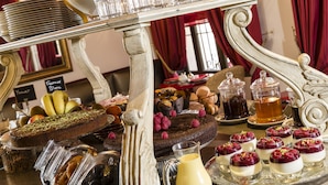 A dessert buffet with various cakes, pastries, and beverages. - Cavendish (Cannes)
