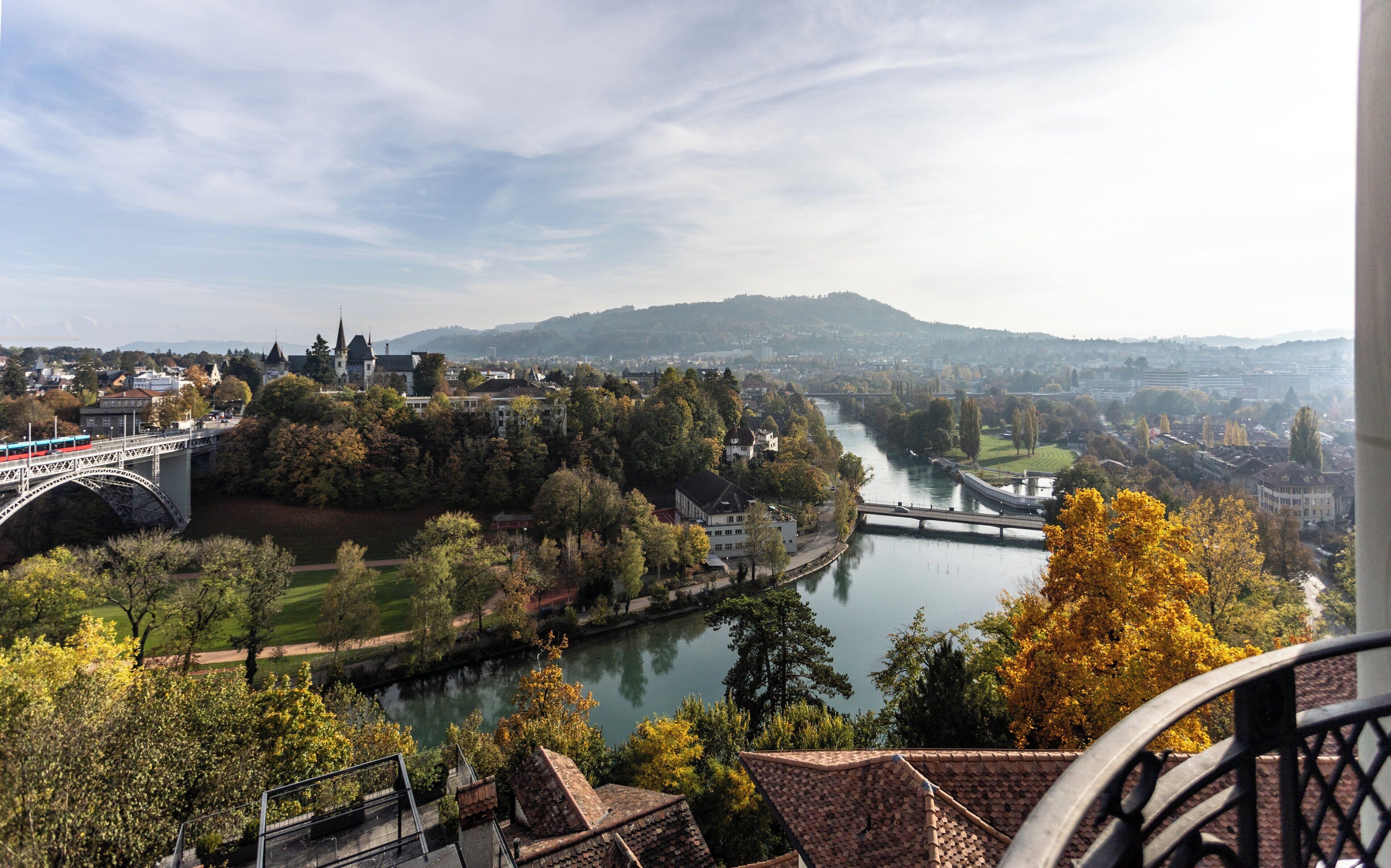 A river with bridges, trees, and buildings in the background.