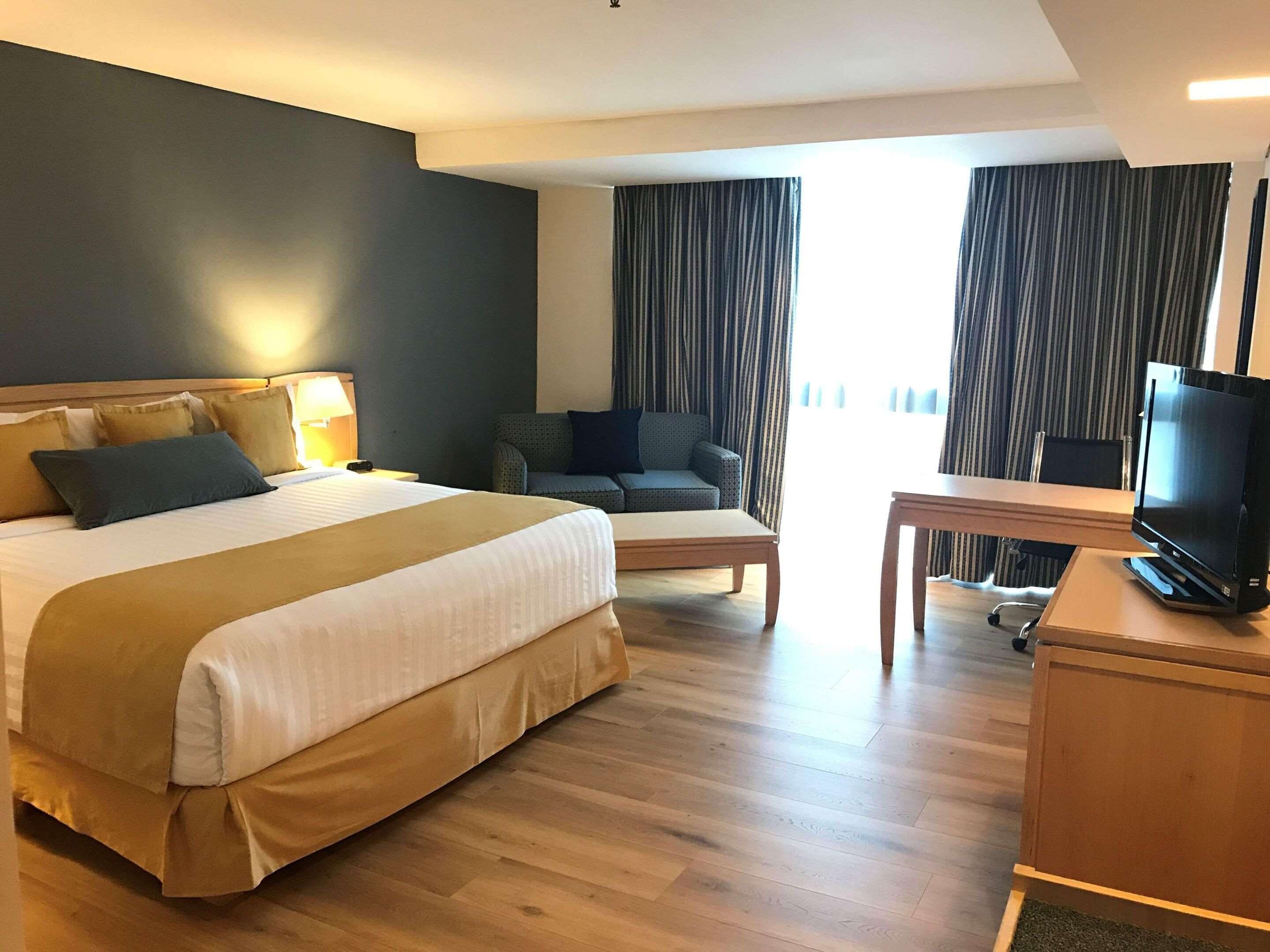 premium room, 1 king bed, non smoking | in-room safe, iron/ironing board, free wifi, bed sheets