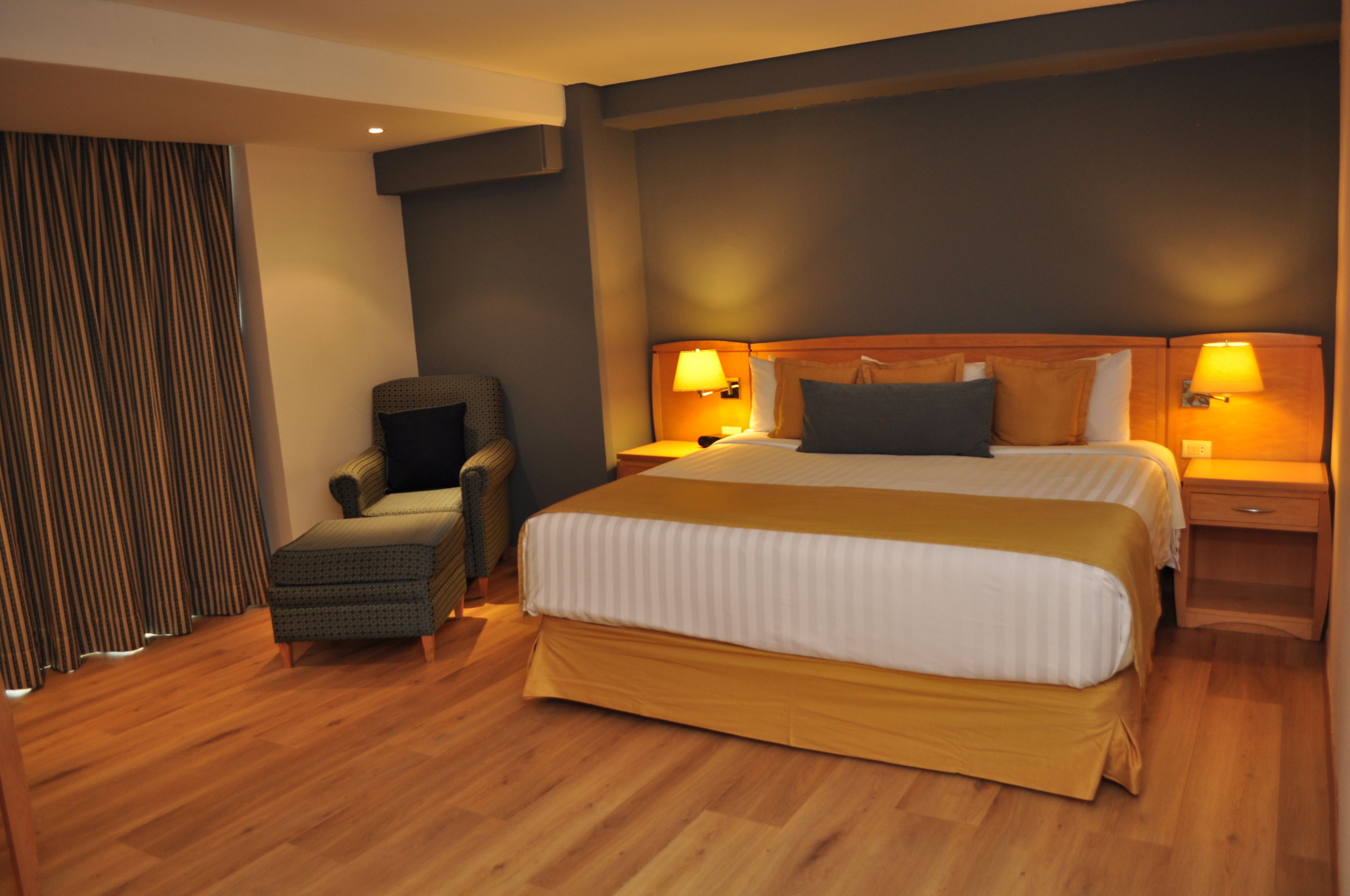 premium room, 1 king bed, non smoking | in-room safe, iron/ironing board, free wifi, bed sheets