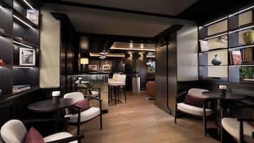 Un interior moderno con una zona de bar, asientos y vista a la cocina.