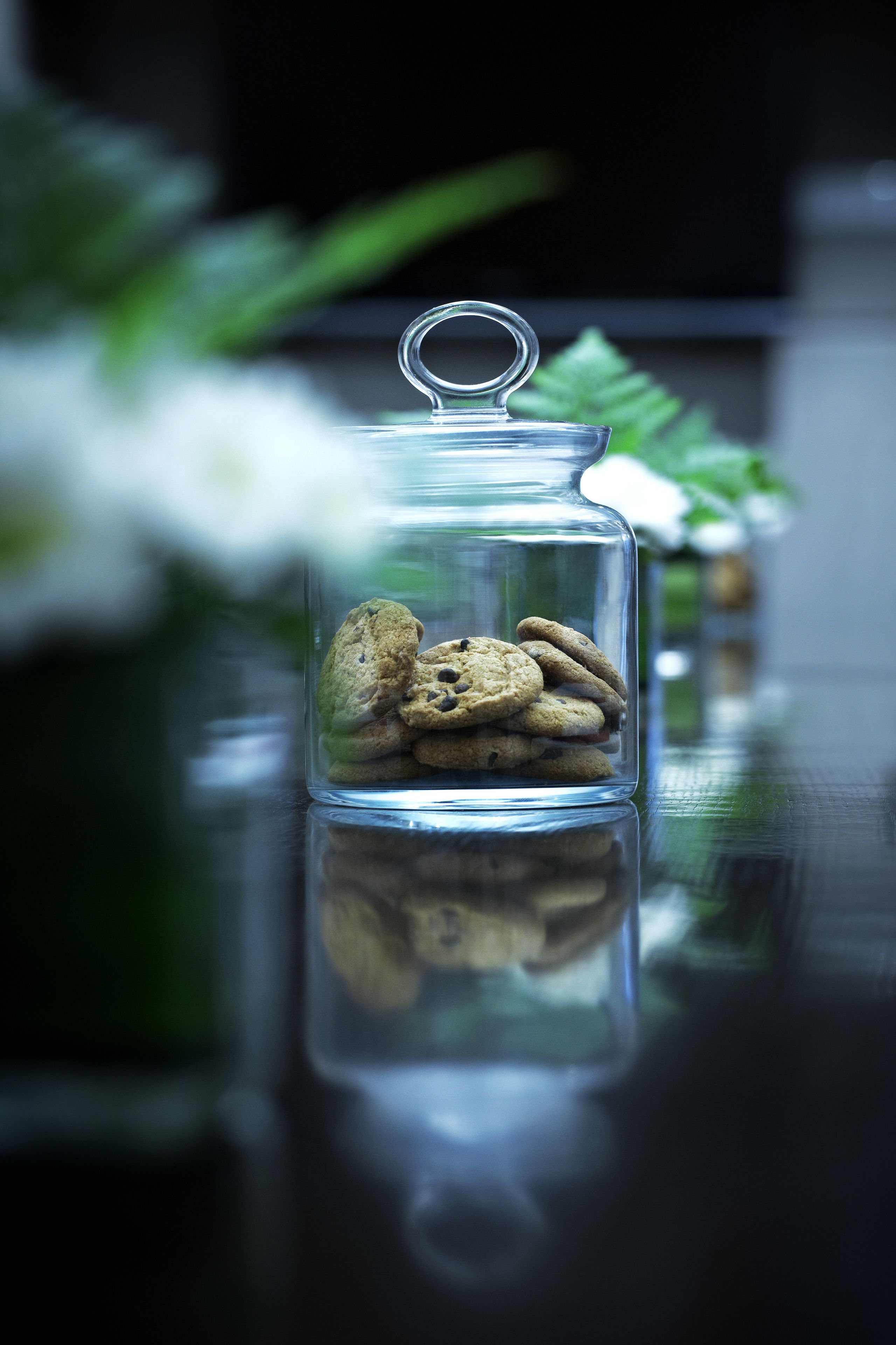 A glass jar with a metal clasp lid containing cookies.