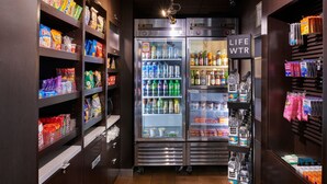 A vending area with snack and drink options, including a LIFE WTR cooler with bottled water and beverages. - Courtyard by Marriott Detroit Livonia (Livonia)