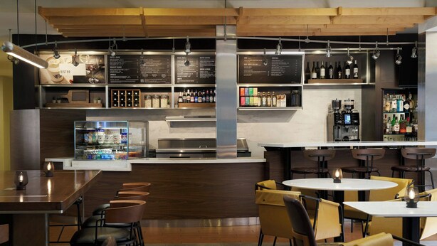 A modern bistro with a bar area, seating arrangements, and a menu display. - Courtyard San Francisco Larkspur Landing/Marin County (Larkspur)