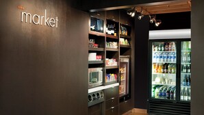 A store with shelves stocked with various products, a refrigerator, and a microwave. - Courtyard San Francisco Larkspur Landing/Marin County (Larkspur)