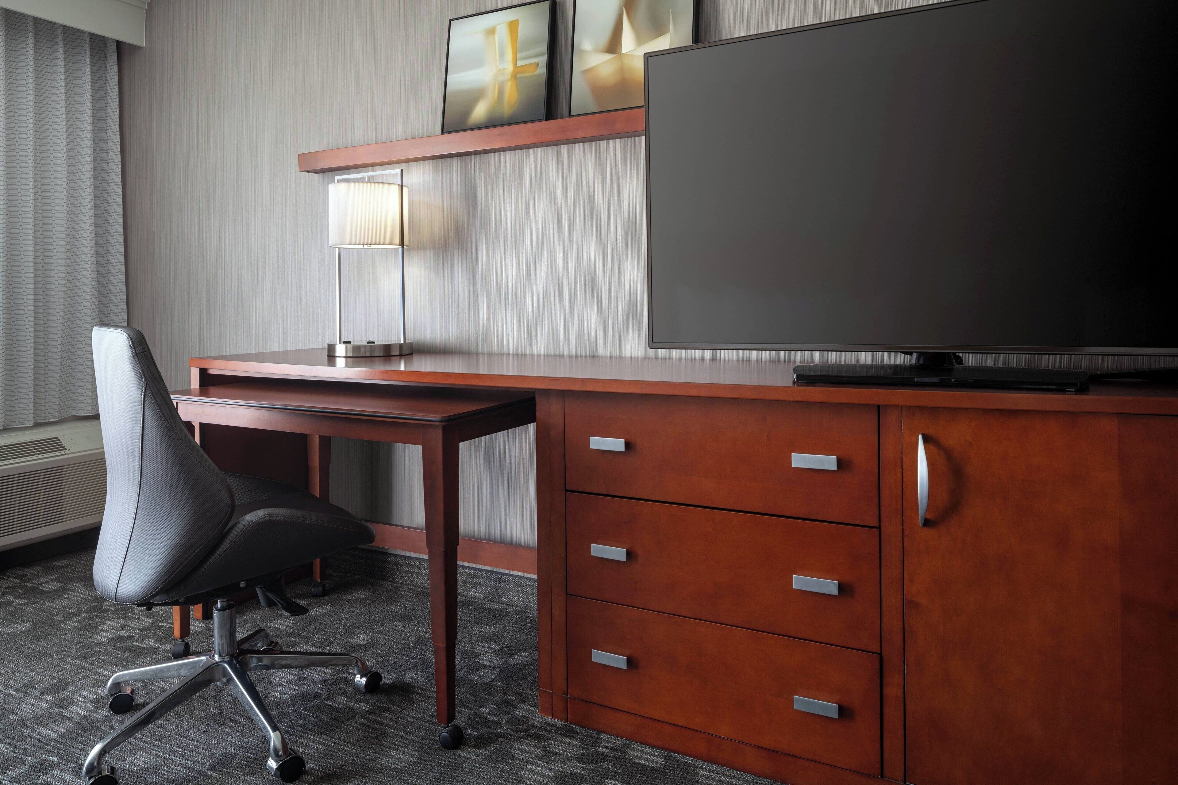 hypo-allergenic bedding, desk, laptop workspace, blackout curtains