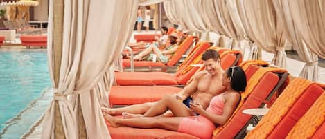 A poolside area with sun loungers and a pool.