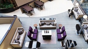 Amplia zona de estar al aire libre con diversas opciones de asientos, incluyendo sofás y sillones, organizados alrededor de una mesa central.