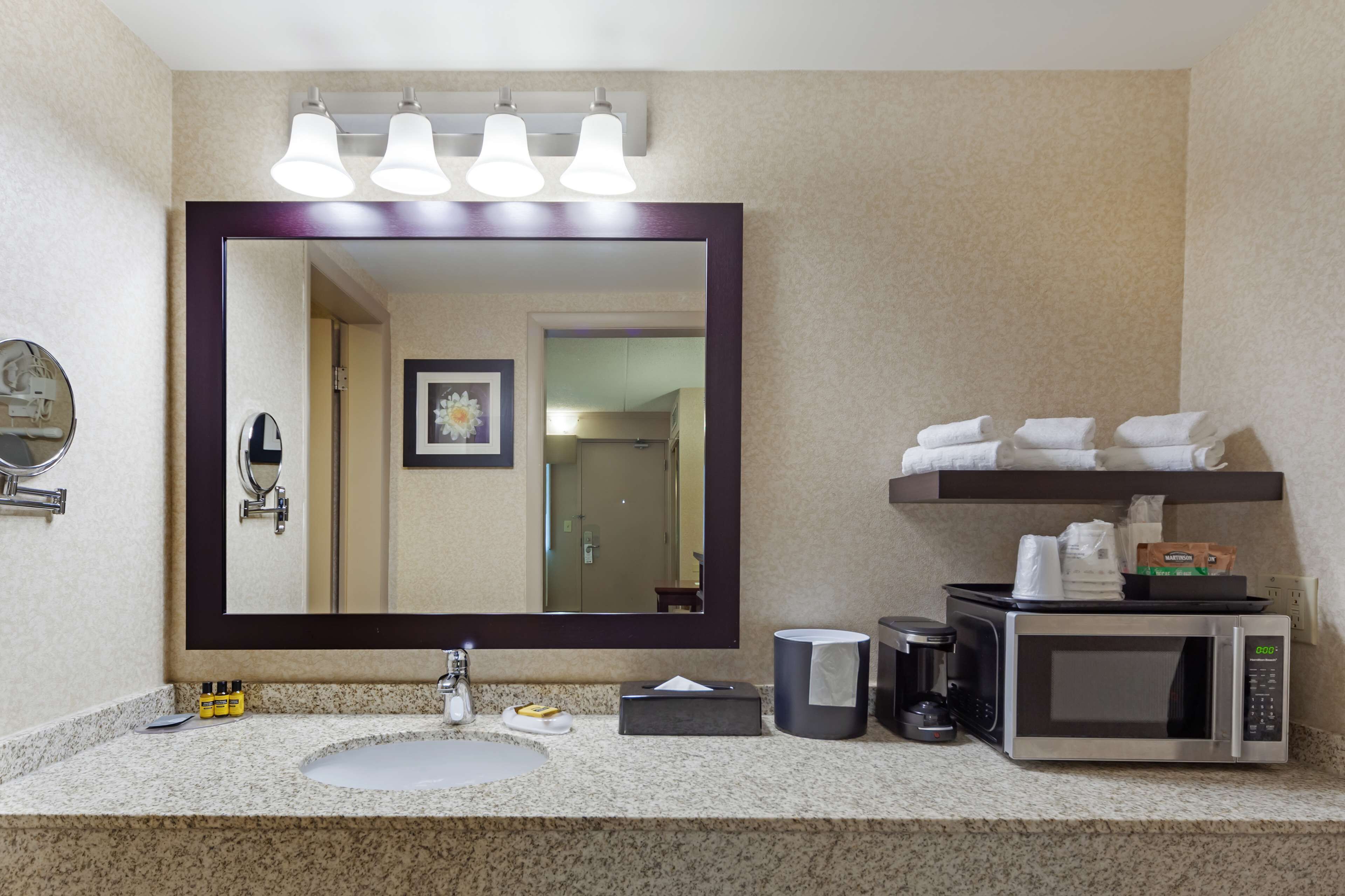 combined shower/bathtub, designer toiletries, hair dryer, towels