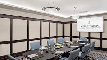 A conference room with a long table, chairs, and a banner reading 'Intercontinental Chicago Magnificent Mile.'