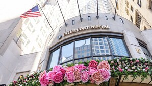 The Intercontinental hotel facade with a large American flag and a floral display. - InterContinental Chicago Magnificent Mile by IHG (Chicago)