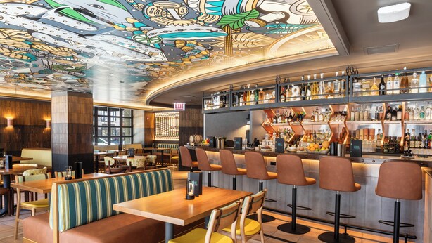 A bar area with a high bar counter, multiple stools, and a seating area with booths and tables. - InterContinental Chicago Magnificent Mile by IHG (Chicago)