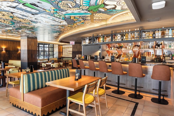 A bar area with a high bar counter, multiple stools, and a seating area with booths and tables. - InterContinental Chicago Magnificent Mile by IHG (Chicago)