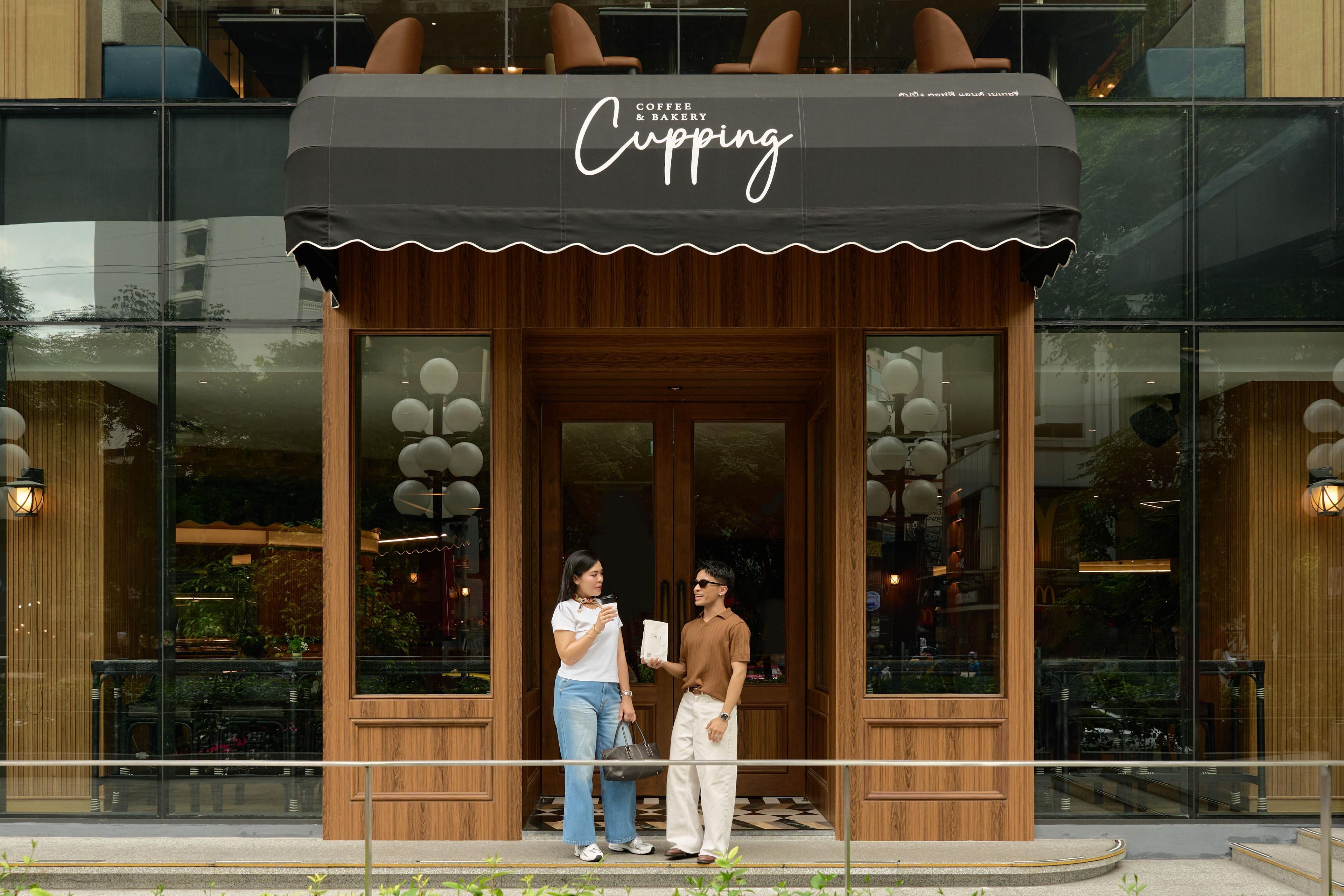A coffee and bakery shop with a wooden facade and large windows.