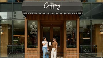 A coffee and bakery shop with a wooden facade and large windows.