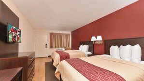 A hotel room with two beds, a TV on the wall, a desk, and a window with curtains. - Red Roof Inn Marietta (Marietta)