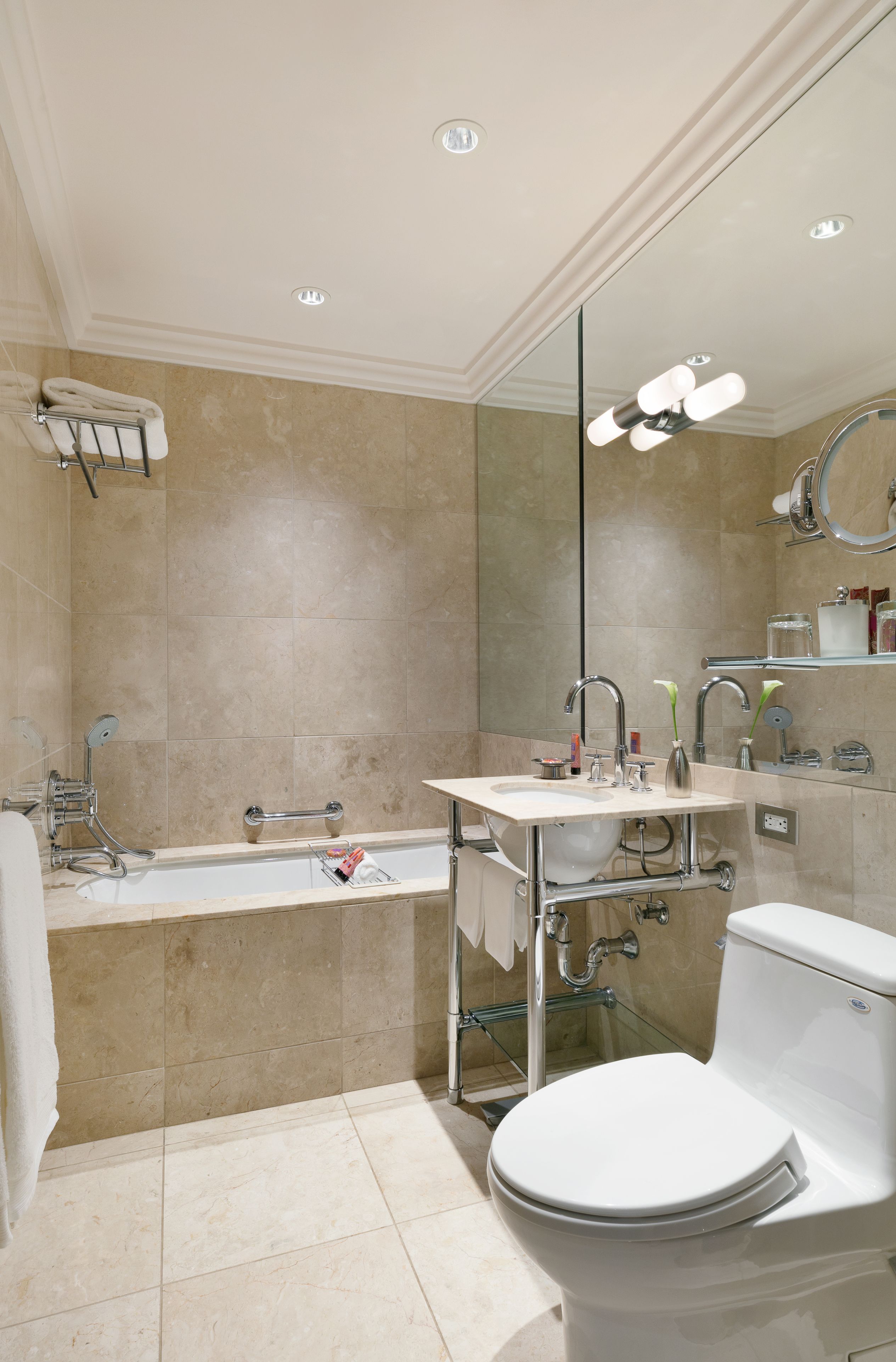 A modern bathroom with a bathtub, sink, and toilet.