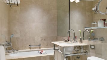 A modern bathroom with a bathtub, sink, and toilet.