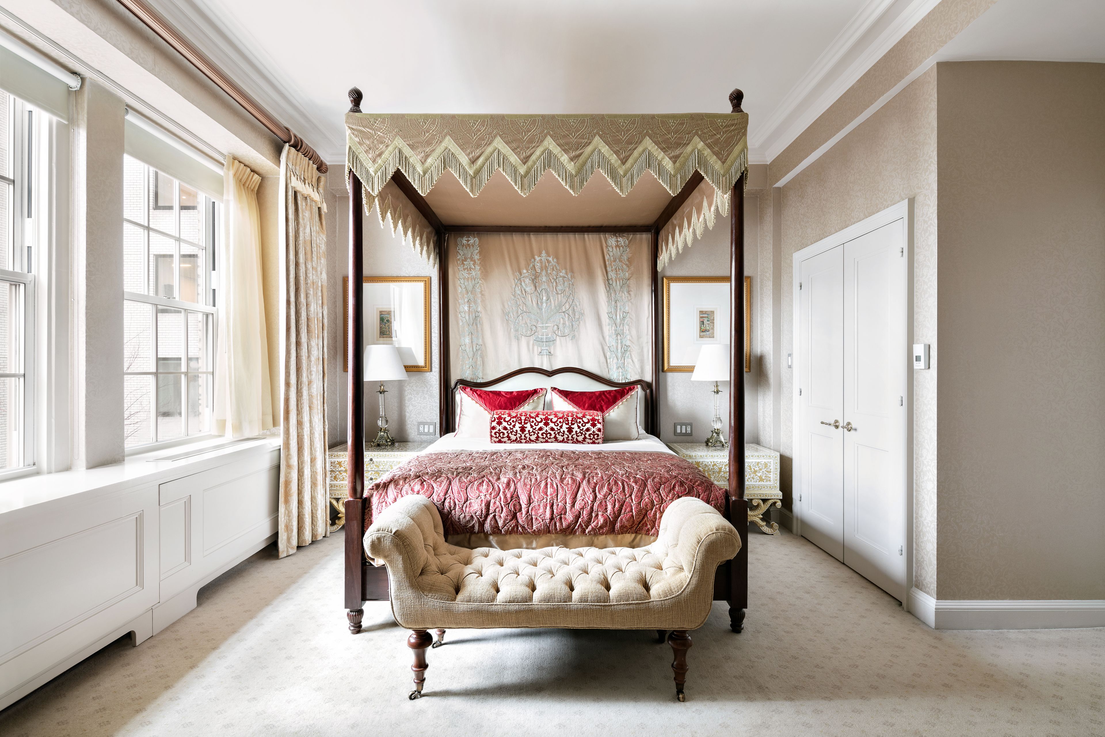 A four-poster canopy bed with a tufted headboard, a footboard, and a matching canopy.