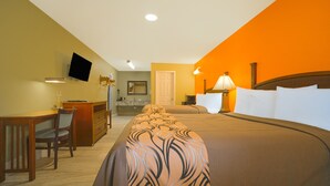 A hotel room with a bed, desk, chair, and a television on the wall. - Aransas Bay Inn & Suites Corpus Christi by OYO (Aransas Pass)