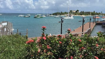 A marina with boats, a wooden dock, and a sign indicating 'Sullivan Bay Sports Fishing'.