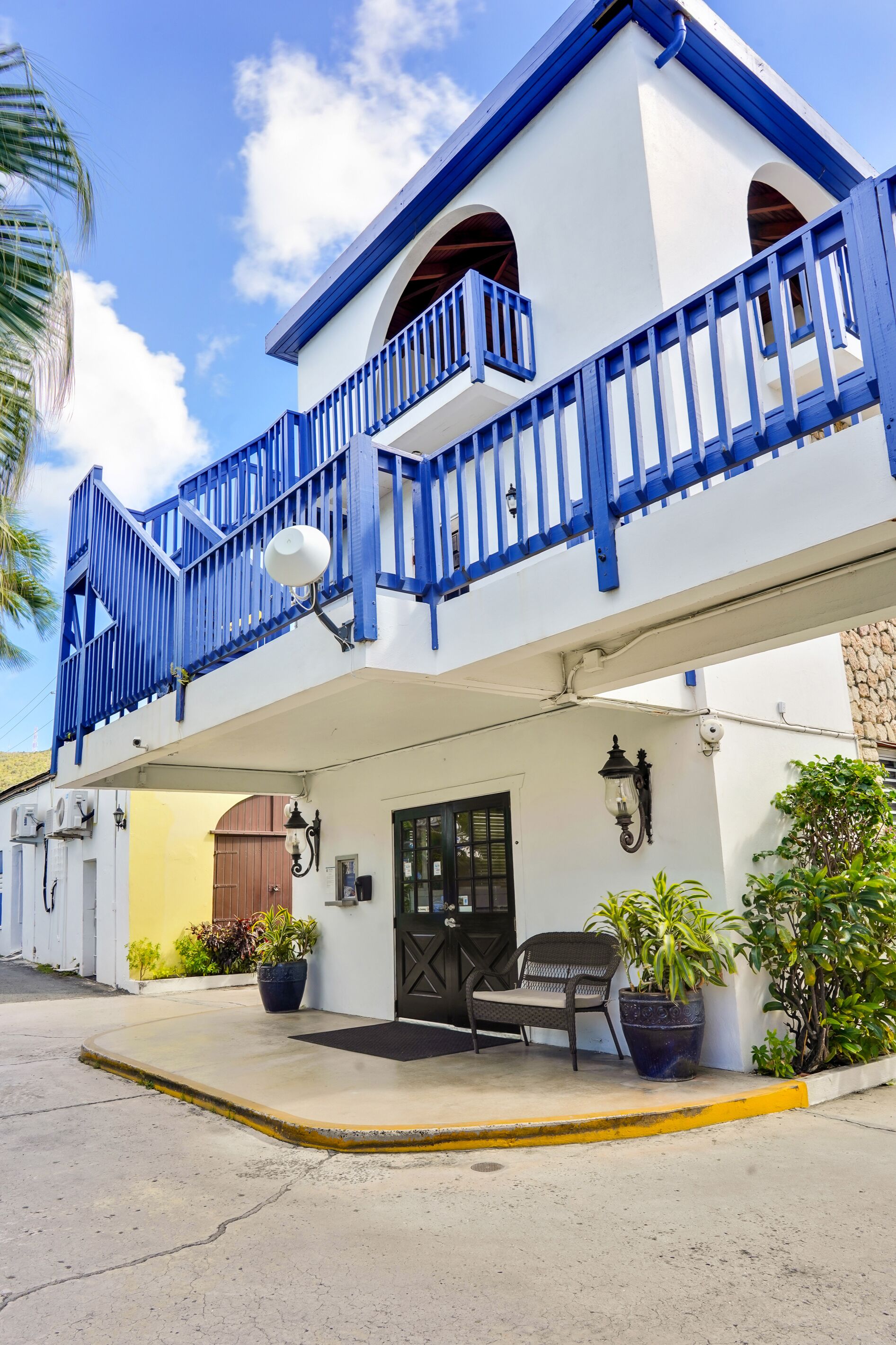 A two-story building with a balcony and a door.