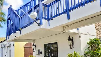 A two-story building with a balcony and a door.